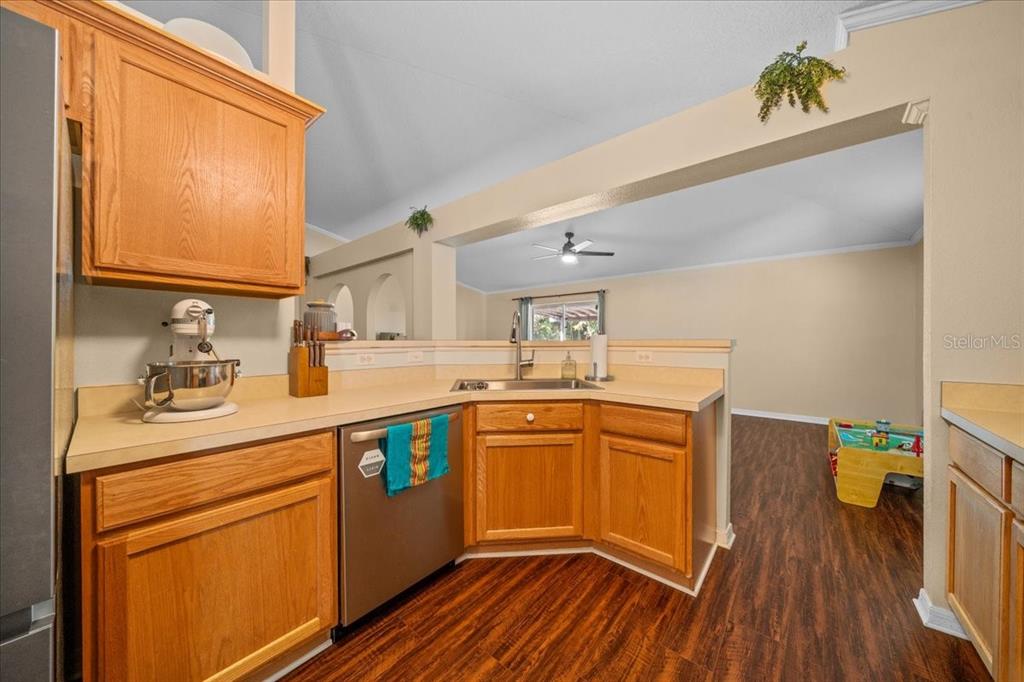 49 Hemlock Radial Loop Ocala, FL 34472 - Photo 16 of 50 a kitchen with stainless steel appliances granite countertop wooden cabinets a sink and dishwasher a stove with wooden floor