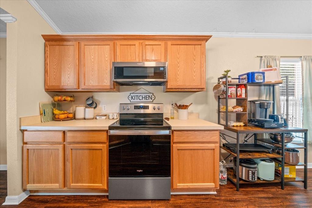 49 Hemlock Radial Loop Ocala, FL 34472 - Photo 17 of 50 a kitchen with stainless steel appliances granite countertop a stove and a refrigerator