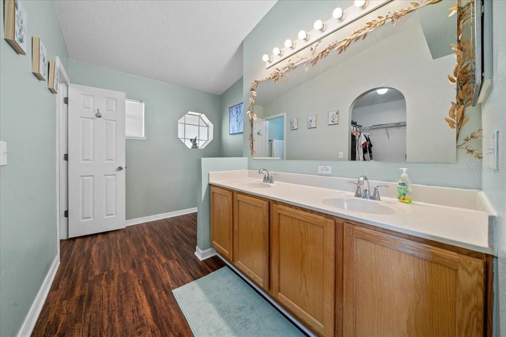 49 Hemlock Radial Loop Ocala, FL 34472 - Photo 28 of 50 a spacious bathroom with a sink a mirror and vanity