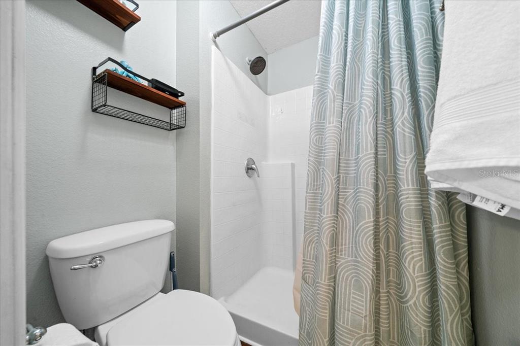 49 Hemlock Radial Loop Ocala, FL 34472 - Photo 29 of 50 a white toilet sitting next to a shower curtain