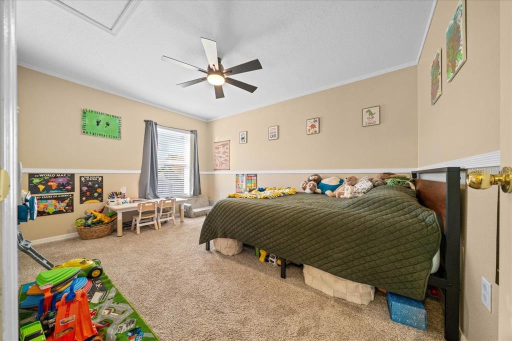 49 Hemlock Radial Loop Ocala, FL 34472 - Photo 30 of 50 a bedroom with a bed and a chandelier