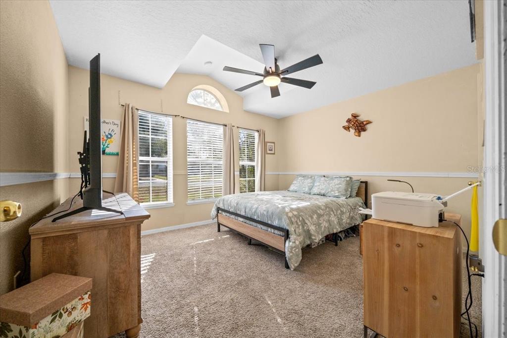 49 Hemlock Radial Loop Ocala, FL 34472 - Photo 32 of 50 a bedroom with a bed and large windows