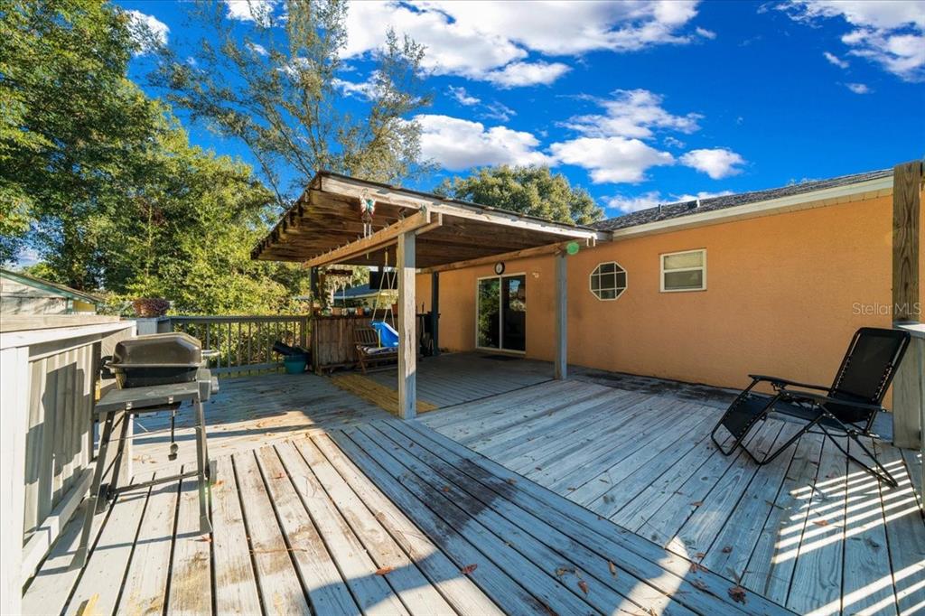 49 Hemlock Radial Loop Ocala, FL 34472 - Photo 38 of 50 a view of a patio with chair and wooden floor