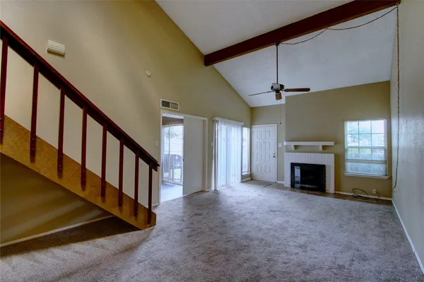 a view of entryway and hall with a fireplace