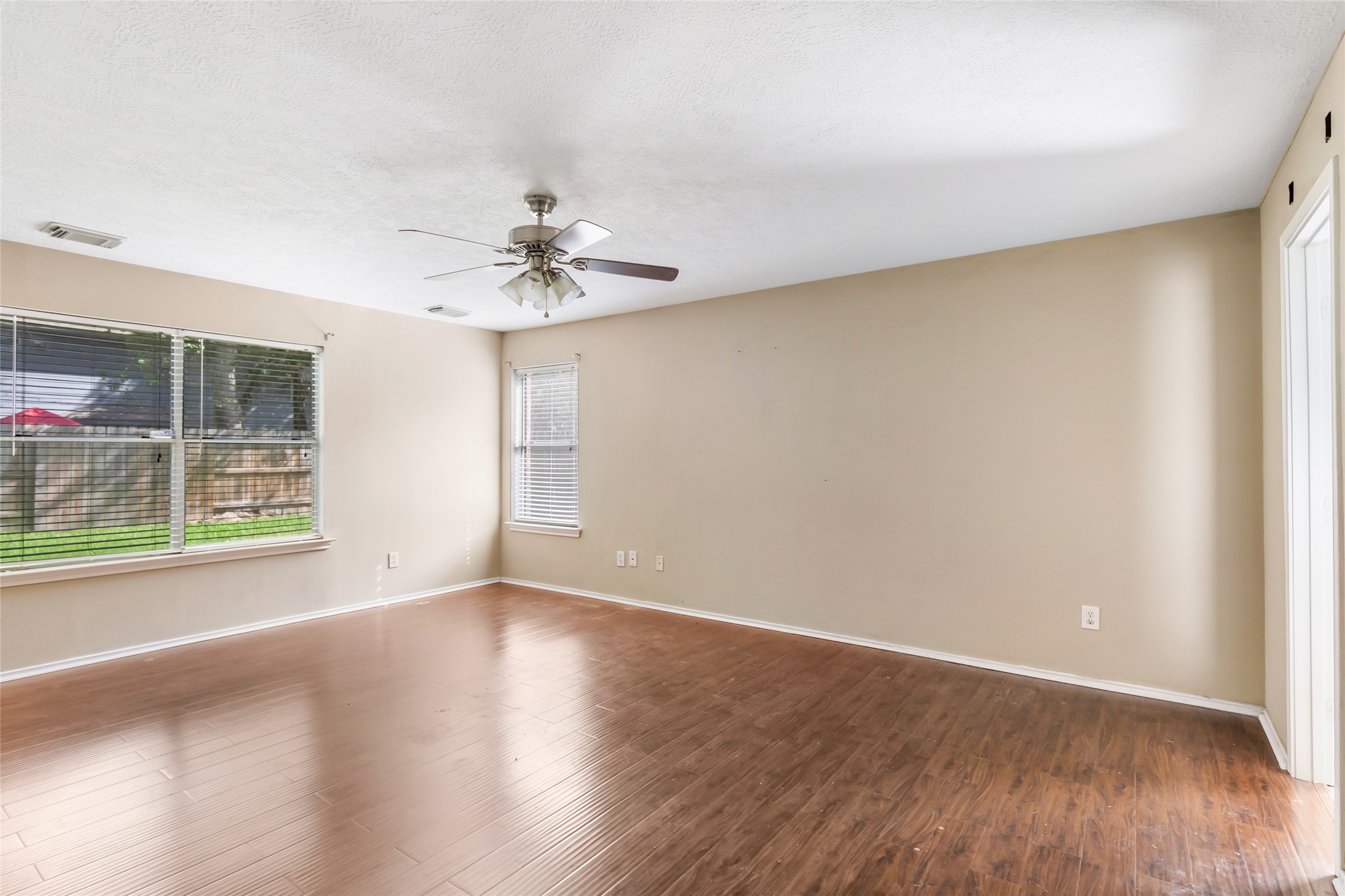 19226 Pinewood Mist Lane Humble, TX 77346 - Photo 27 of 33 wooden floor in an empty room with a window