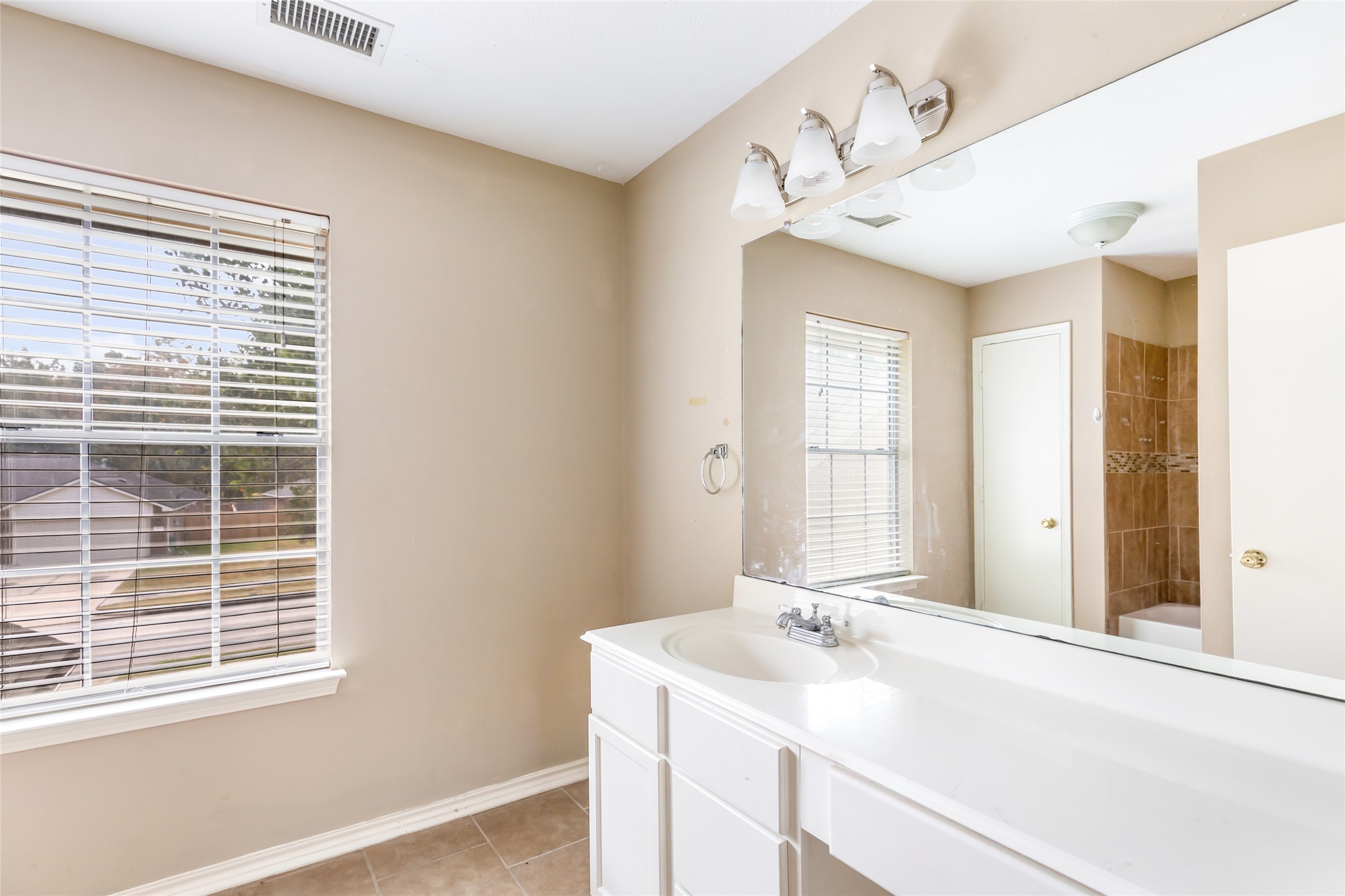 19226 Pinewood Mist Lane Humble, TX 77346 - Photo 31 of 33 a bathroom with a sink and a mirror