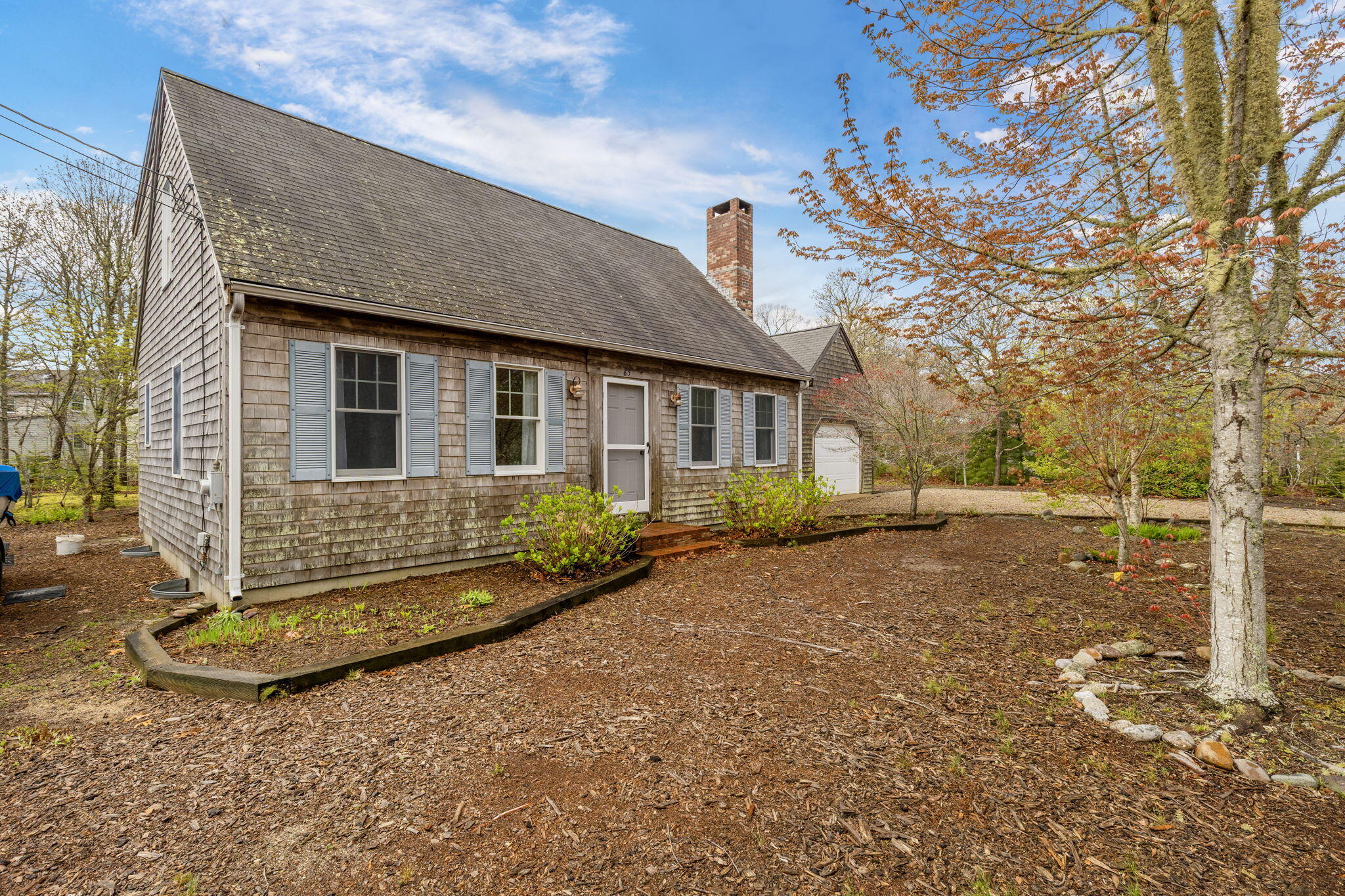 65 Whitney Road Eastham, MA 02642 - Photo 3 of 41 a front view of a house with a yard