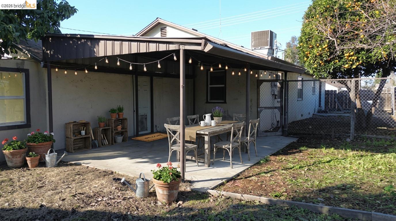 5100 Kiernan Avenue Salida, CA 95368 - Photo 12 of 45 a view of a patio with table and chairs potted plants and floor to ceiling window
