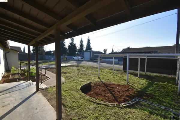 a kitchen with stainless steel appliances kitchen island a table chairs in it and wooden floors