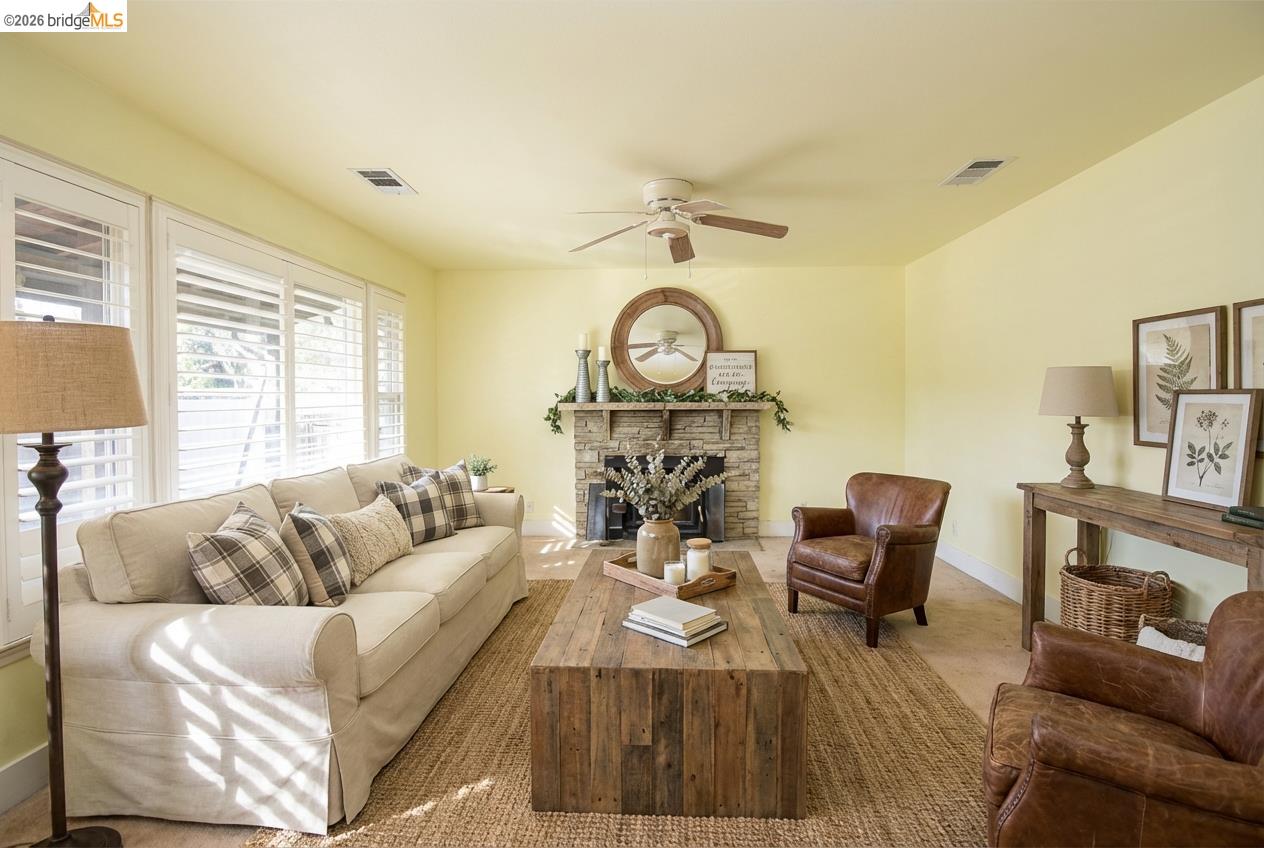5100 Kiernan Avenue Salida, CA 95368 - Photo 20 of 45 a living room with furniture a fireplace and a large window