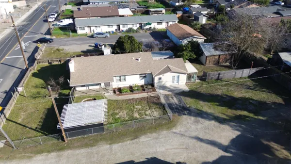 an aerial view of a house with a yard