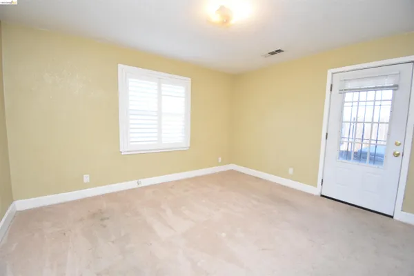 a view of an empty room with a window