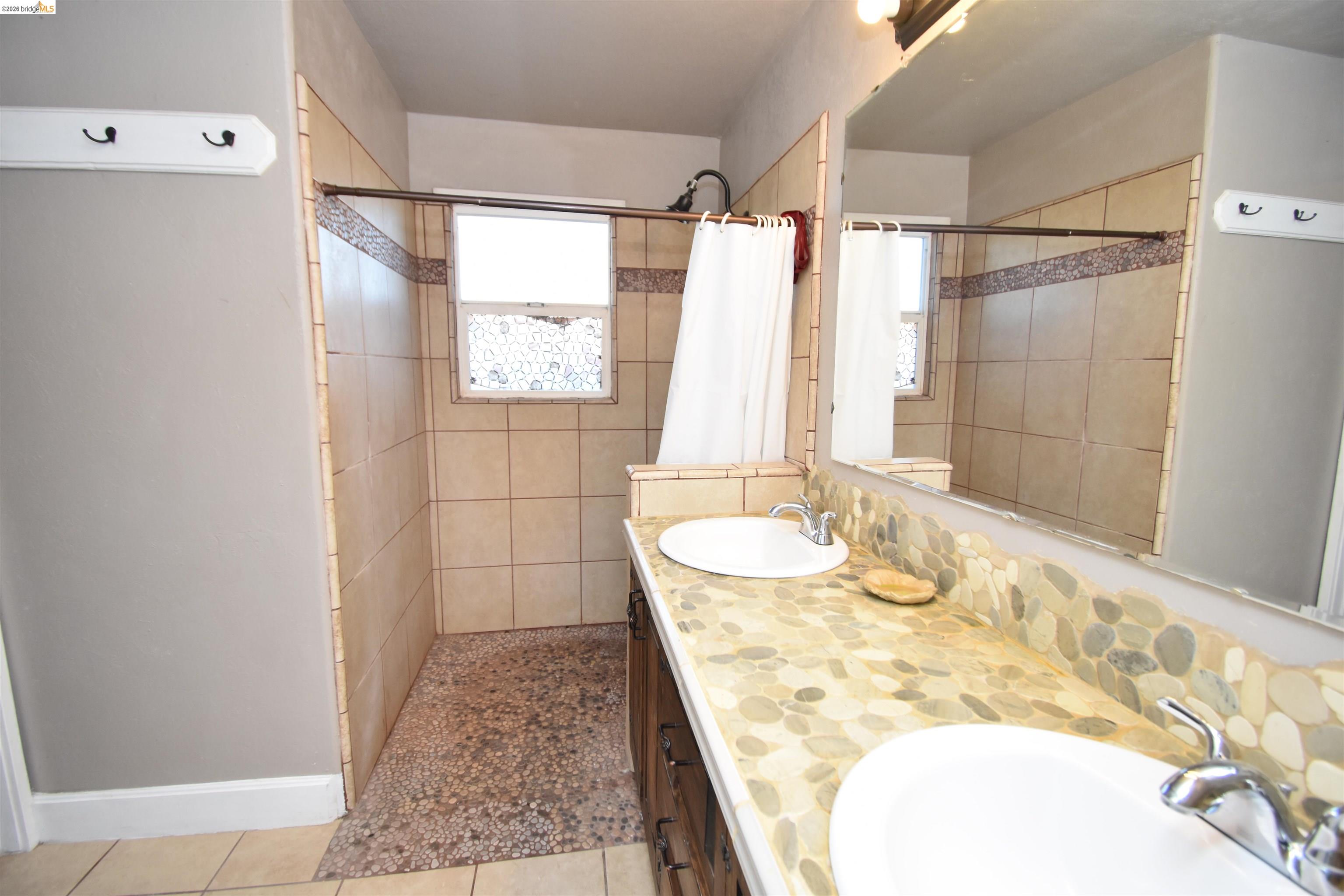 5100 Kiernan Avenue Salida, CA 95368 - Photo 28 of 45 a bathroom with a granite countertop shower sink and mirror