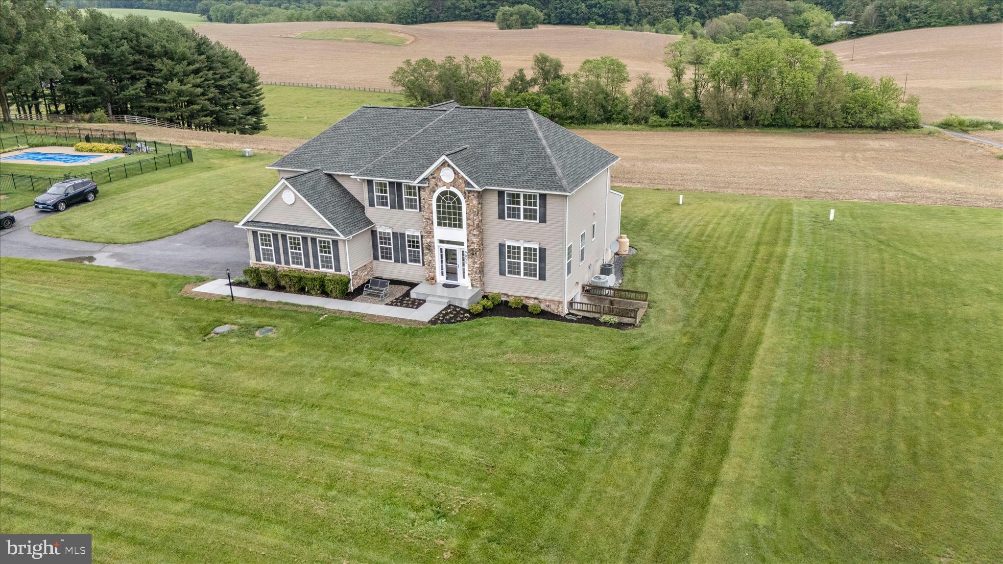 9855 McKinstry Mill Road New Windsor, MD 21776 - Photo 2 of 76 a aerial view of a house with a yard and lake view