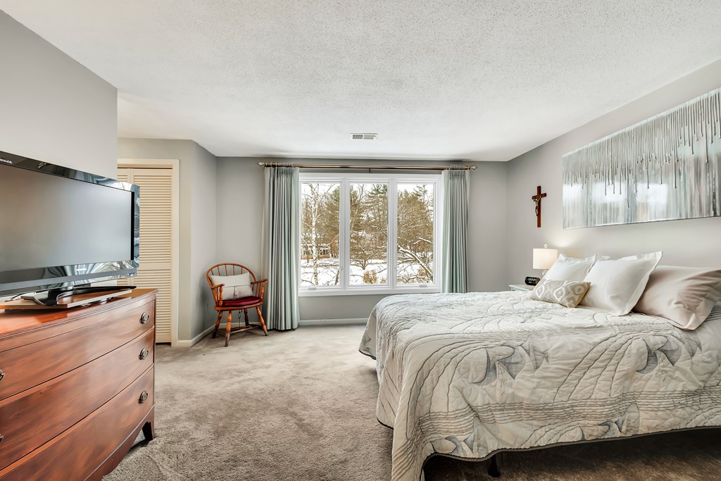 2 Kingman Road Acton, MA 01720 - Photo 13 of 28 a bedroom with a bed and large flat screen tv