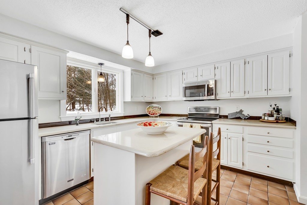 2 Kingman Road Acton, MA 01720 - Photo 6 of 28 a kitchen with white cabinets and white appliances