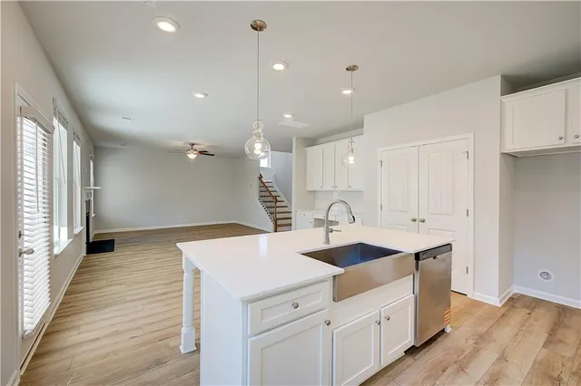 a kitchen with a sink appliances and cabinets