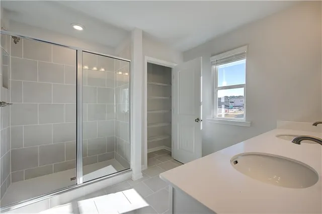 a bathroom with a shower sink and mirror