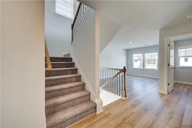 a view of staircase with wooden floor and windows