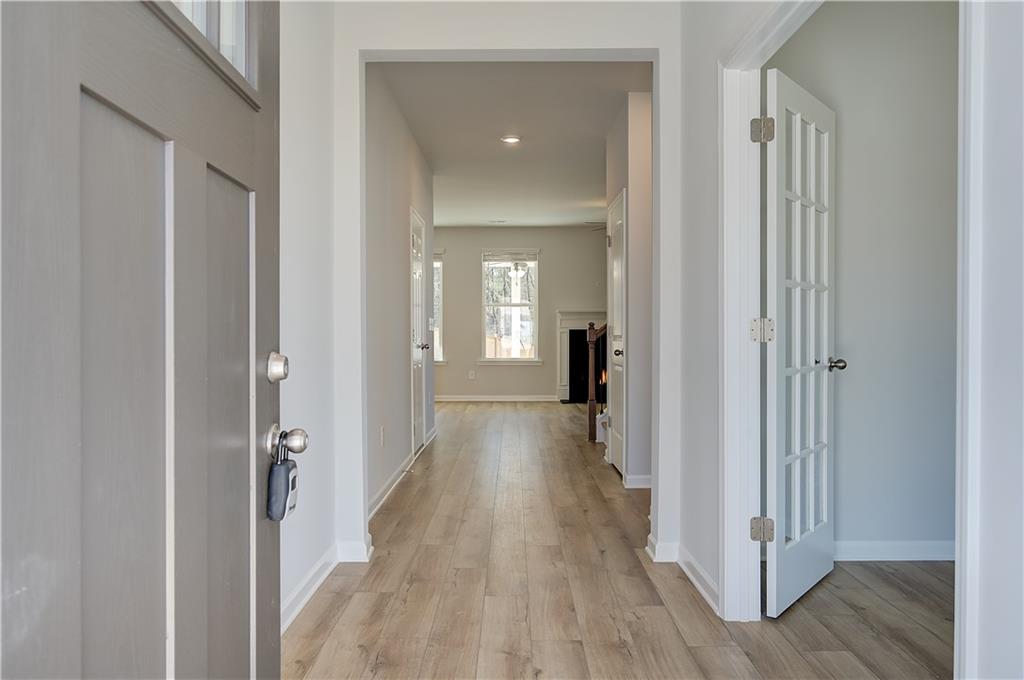 305 Exeter Court Stockbridge, GA 30281 - Photo 4 of 27 a view of a hallway with wooden floor