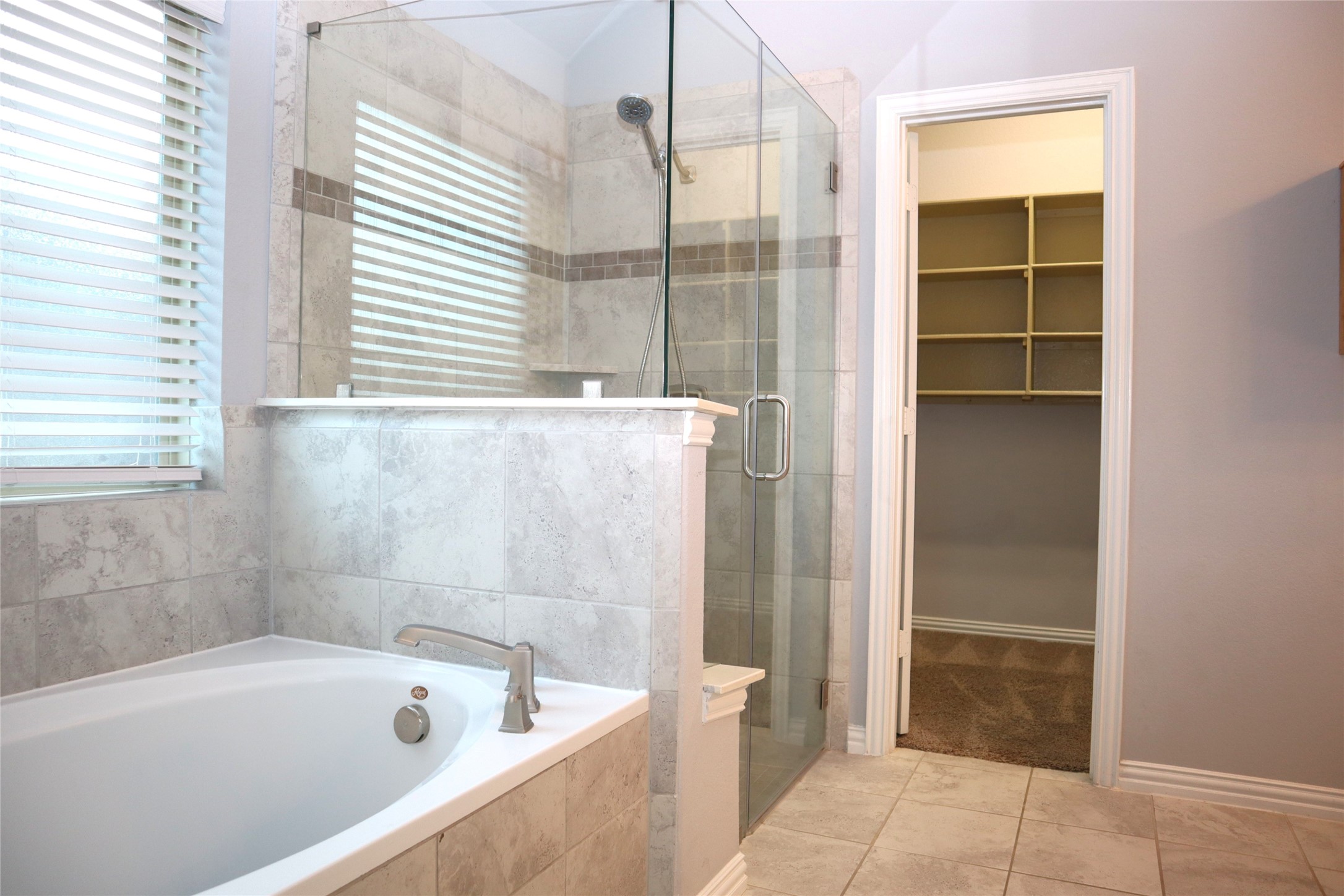 4553 New Country Drive Spring, TX 77386 - Photo 21 of 36 a bathroom with a tub shower and checkered floor