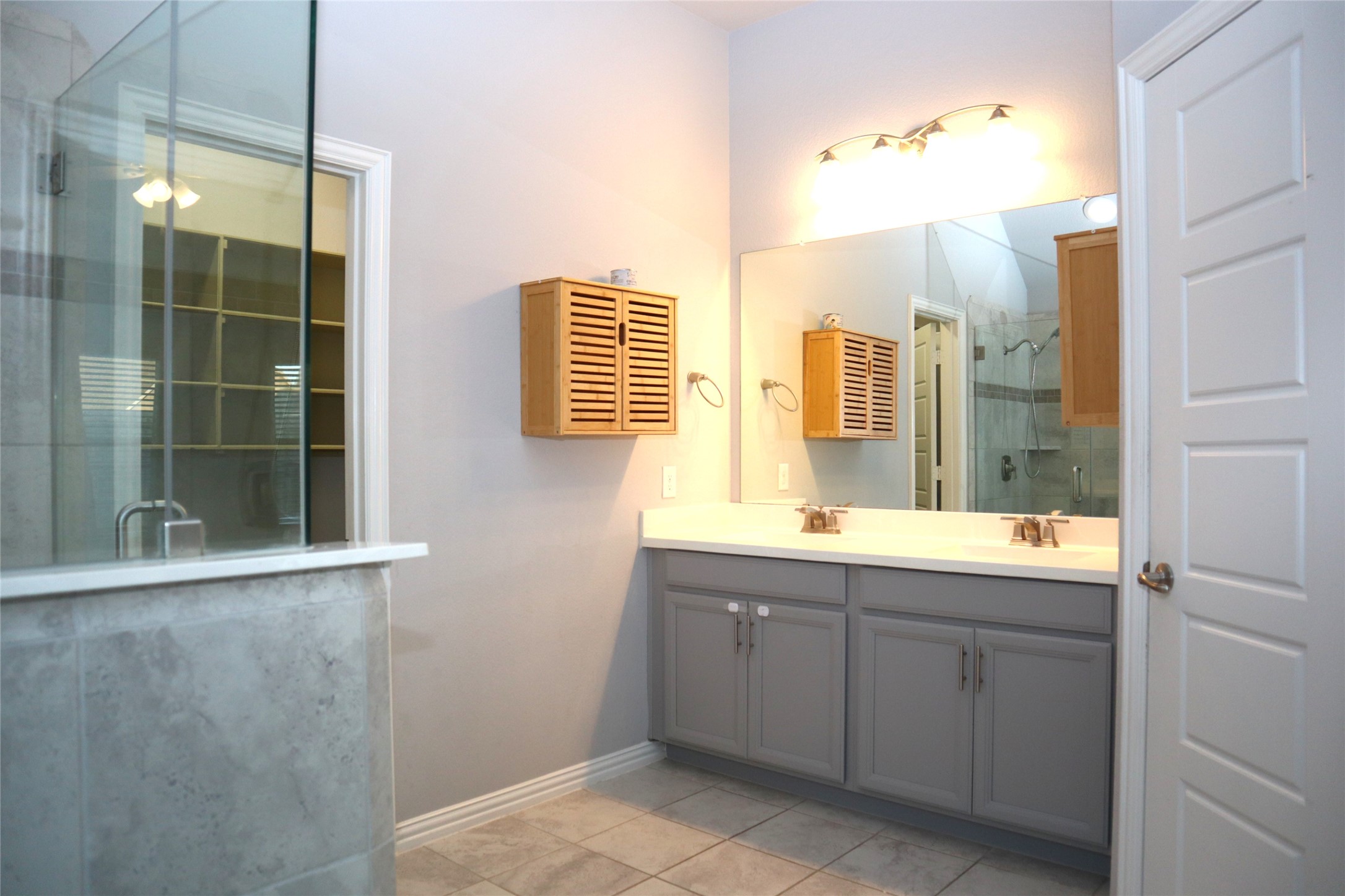 4553 New Country Drive Spring, TX 77386 - Photo 23 of 36 a bathroom with a double vanity sink and mirror