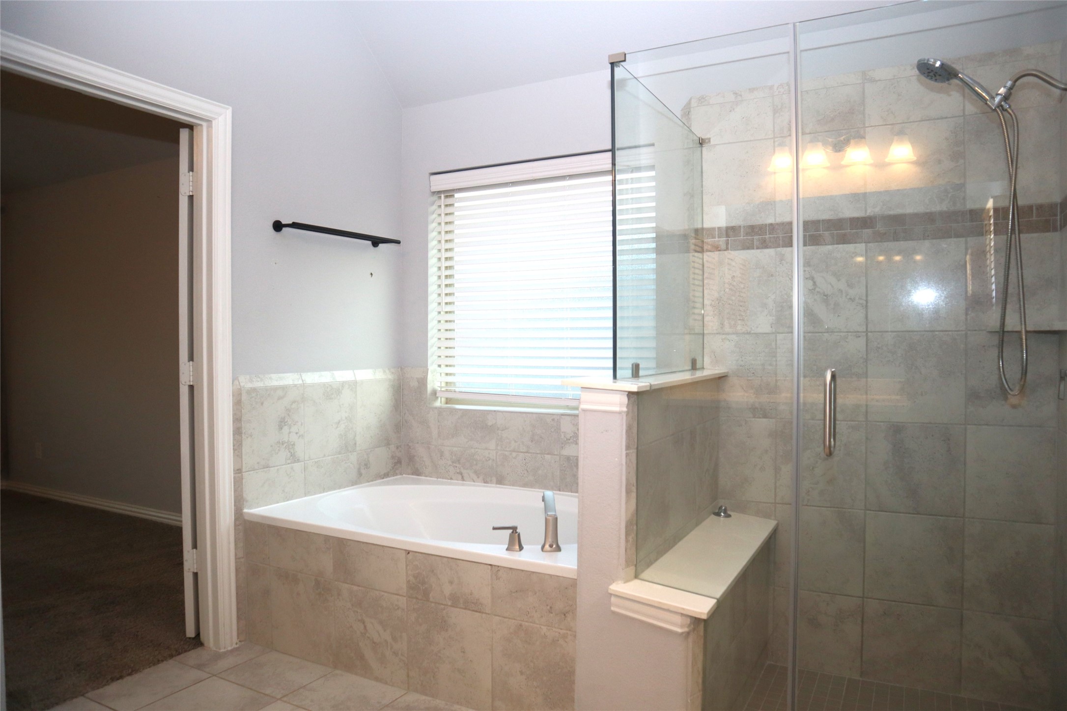 4553 New Country Drive Spring, TX 77386 - Photo 24 of 36 a bathroom with a bathtub and shower
