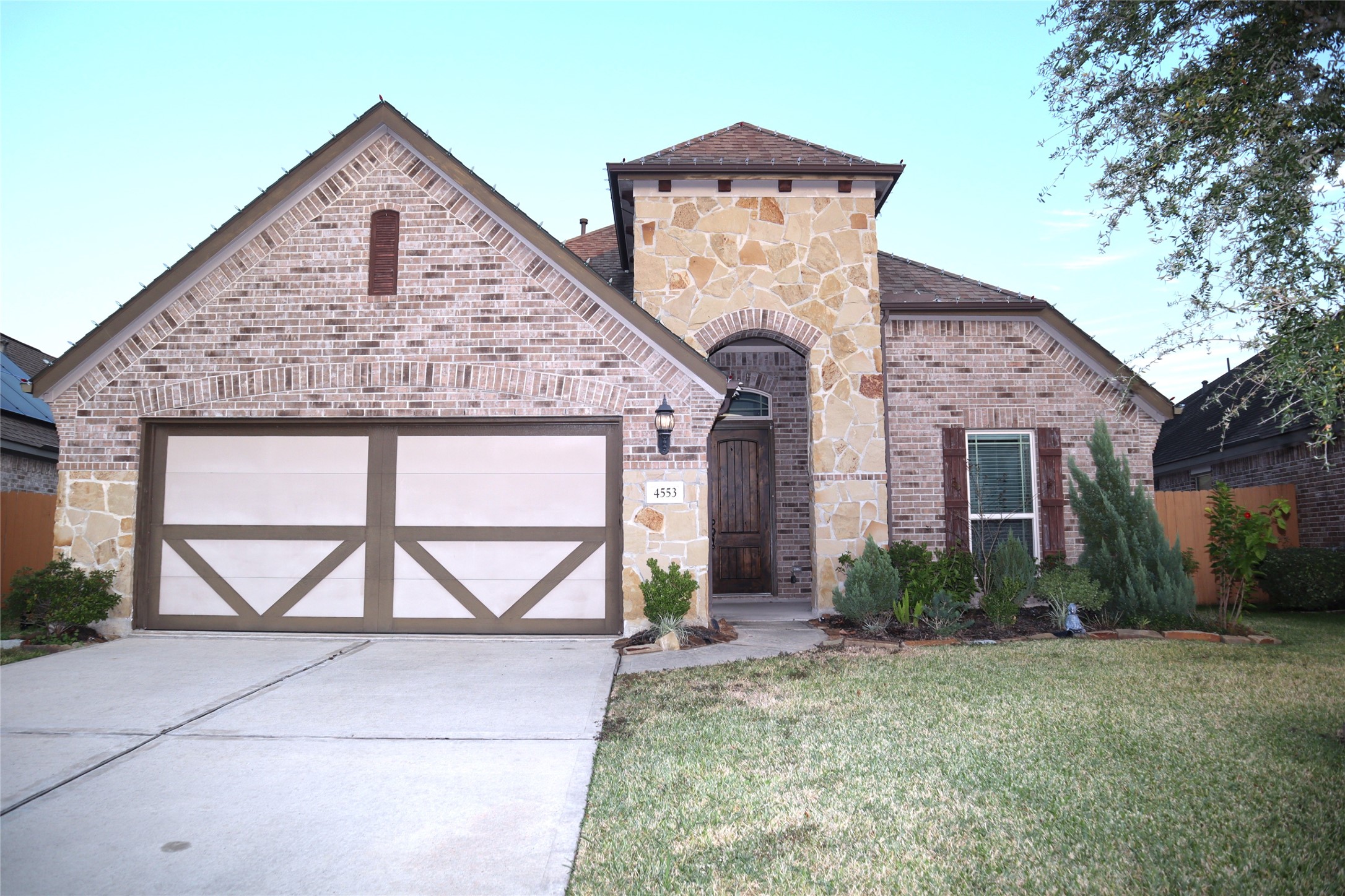 4553 New Country Drive Spring, TX 77386 - Photo 27 of 36 a front view of a house with a yard and garage