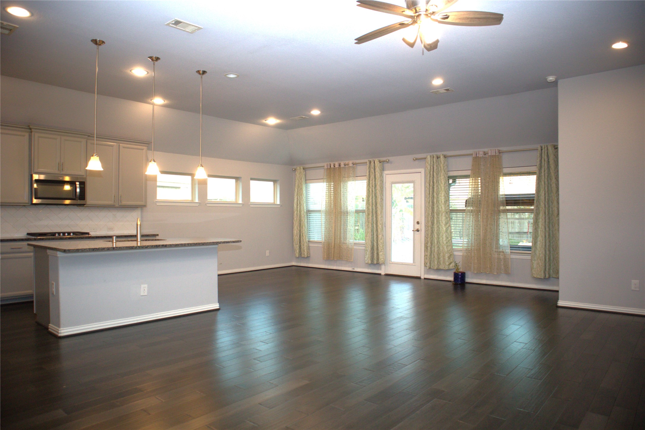 4553 New Country Drive Spring, TX 77386 - Photo 31 of 36 an empty room with wooden floor and entrance to ceiling window