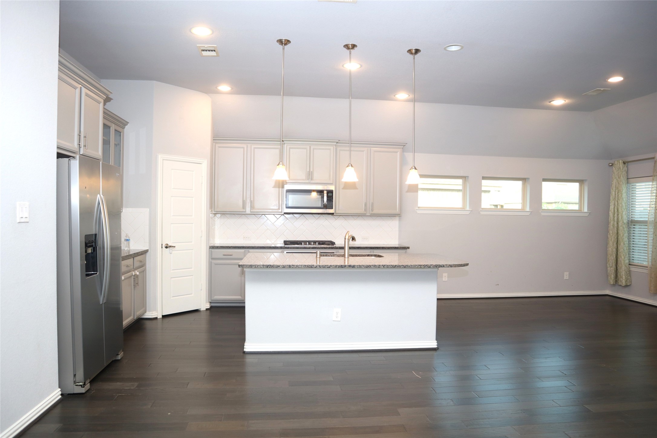 4553 New Country Drive Spring, TX 77386 - Photo 32 of 36 a kitchen with stainless steel appliances granite countertop a sink a stove and a refrigerator