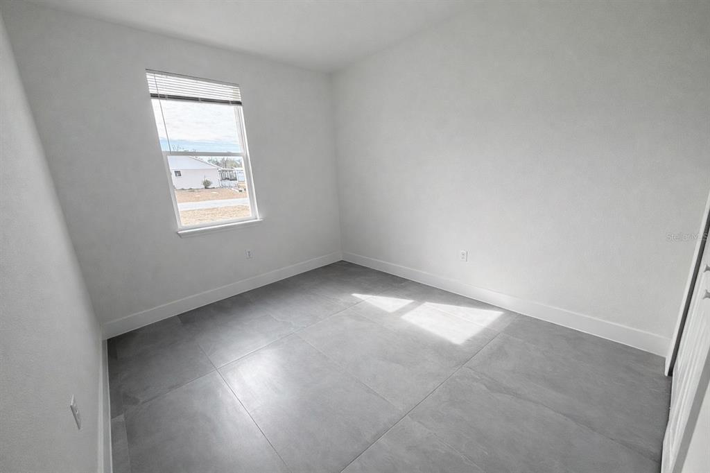 4837 Southwest 138th Lane Ocala, FL 34473 - Photo 23 of 24 an empty room with a window