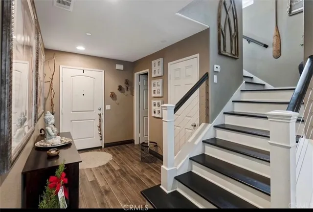 a view of entryway with wooden floor and stairs