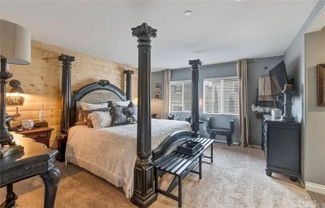 a bedroom with furniture and a chandelier