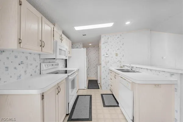 a kitchen with a sink stove and refrigerator
