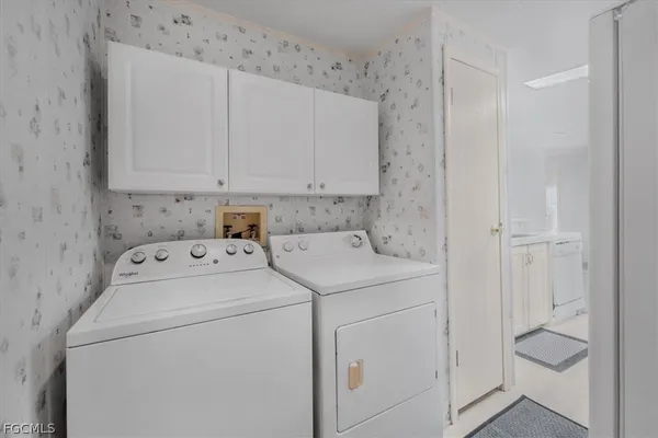 a view of storage and utility room with washer and dryer