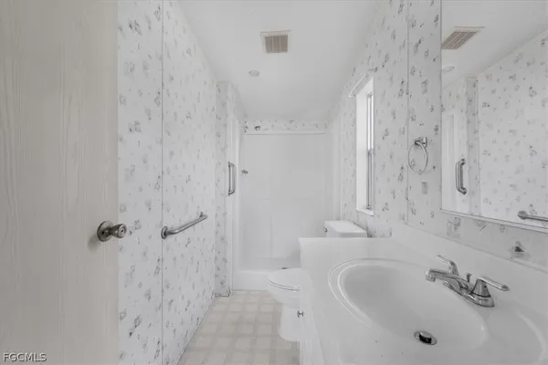 a bathroom with shower sink