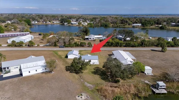 an aerial view of a house with a lake view and mountain view