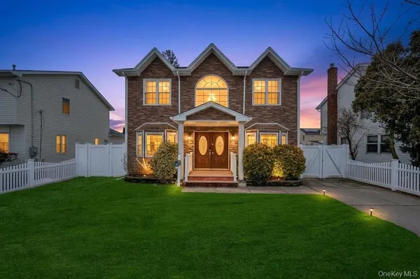 a front view of a house with a yard table and chairs