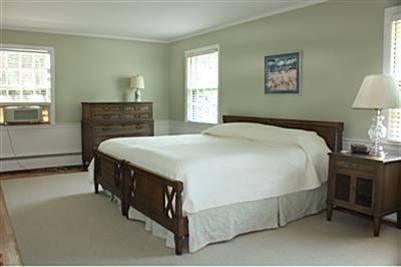 127 Old Salt Works Road Chatham, MA 02633 - Photo 6 of 10 a bedroom with a bed and a lamp on table