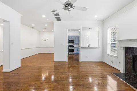 a view of kitchen and hall with wooden floor
