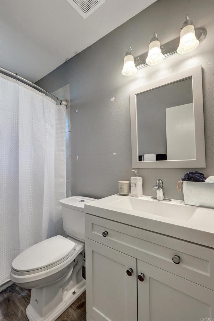 3011 Thunder Drive Oceanside, CA 92056 - Photo 22 of 28 a bathroom with a toilet a sink and mirror
