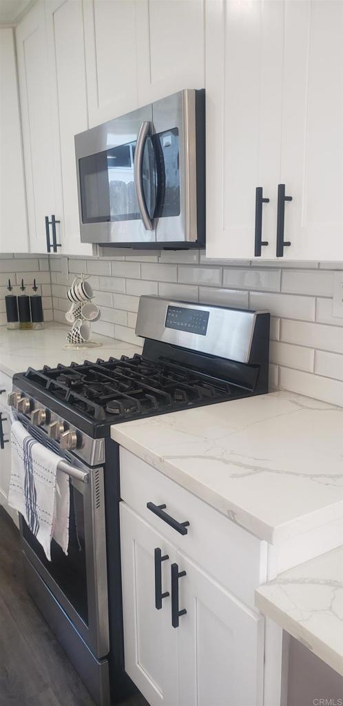 3011 Thunder Drive Oceanside, CA 92056 - Photo 5 of 28 a kitchen with a stove and cabinets