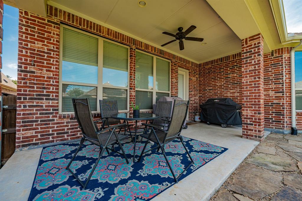 2023 Cutter Crossing Place Wylie, TX 75098 - Photo 16 of 33 a patio with table and chairs and potted plants
