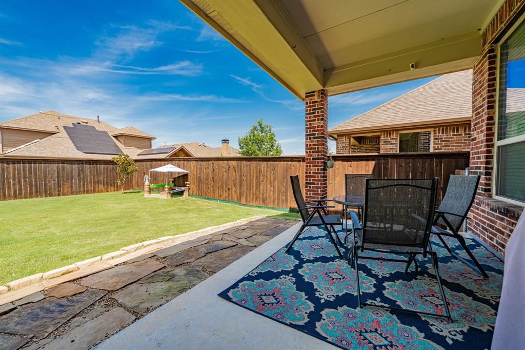 2023 Cutter Crossing Place Wylie, TX 75098 - Photo 17 of 33 a view of a patio with table and chairs with wooden floor and fence