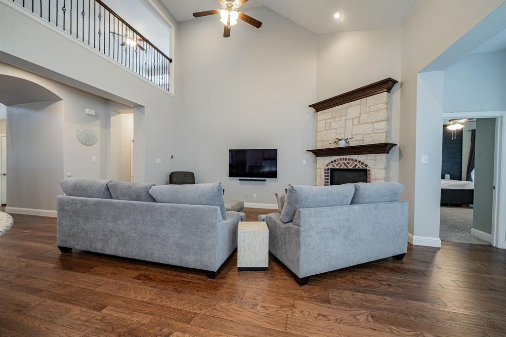 2023 Cutter Crossing Place Wylie, TX 75098 - Photo 26 of 33 a living room with furniture and a fireplace