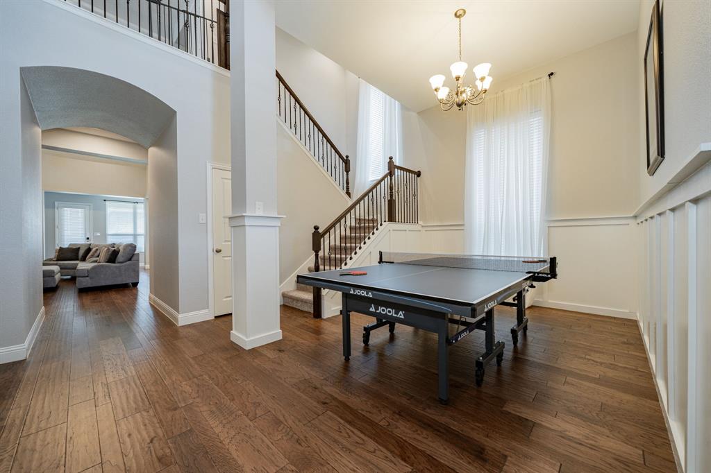 2023 Cutter Crossing Place Wylie, TX 75098 - Photo 29 of 33 a living room with furniture and a wooden floor