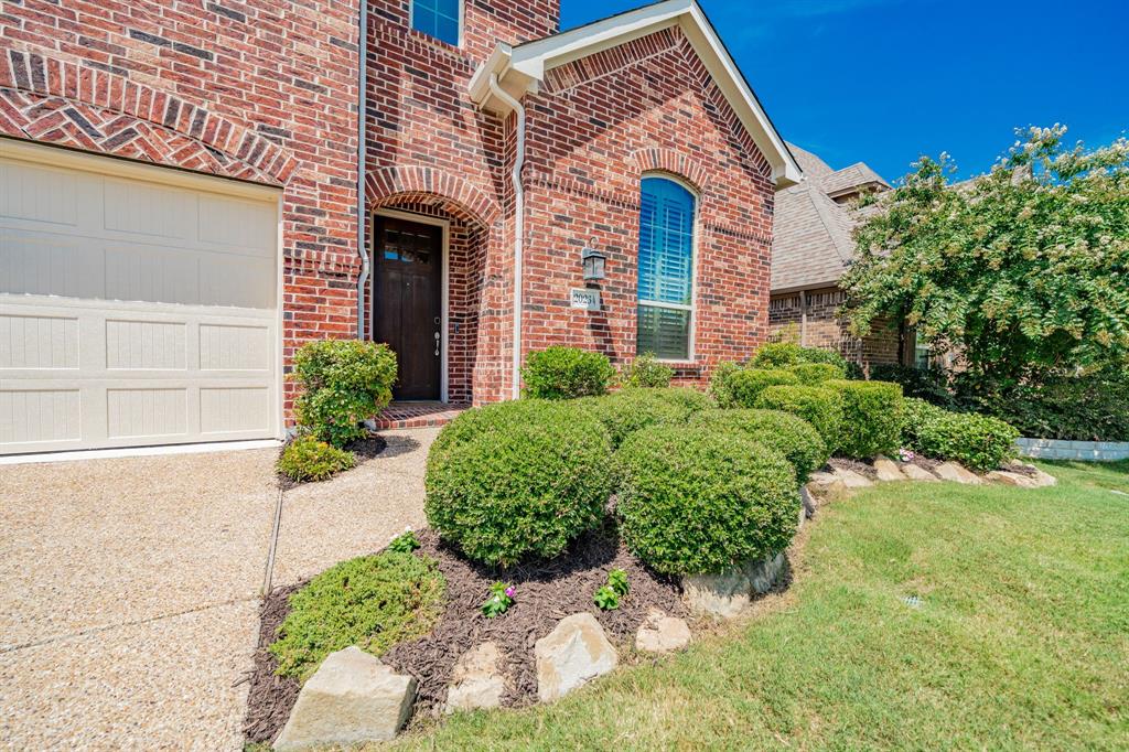 2023 Cutter Crossing Place Wylie, TX 75098 - Photo 3 of 33 a front view of a house with a yard