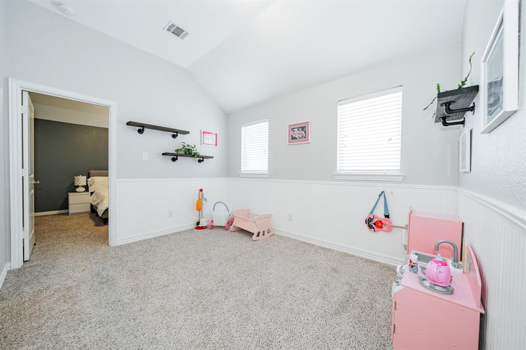 2023 Cutter Crossing Place Wylie, TX 75098 - Photo 9 of 33 a playing room with toys and a baby crib