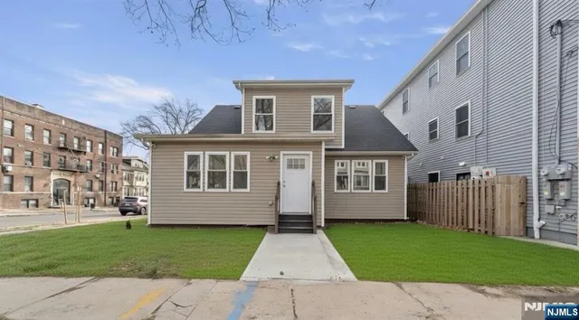 a front view of a house with a garden