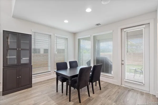 a view of a dining room with furniture and windows